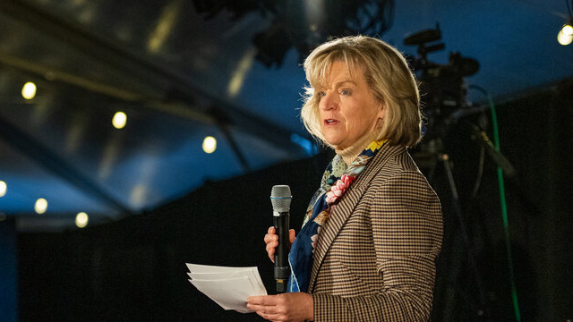 Woman speaking into a microphone