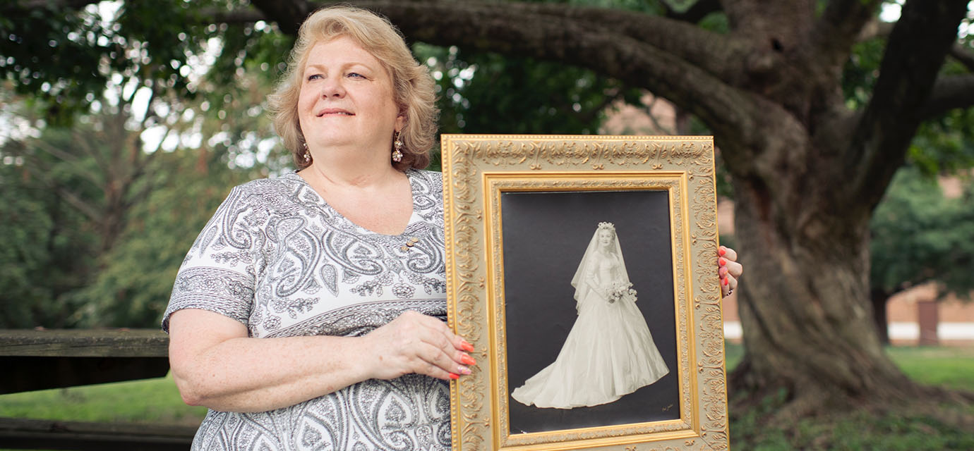 Photo of Christine holding a black and white photograph