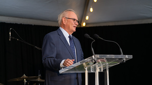 Image of a speaker at the podium during the event for Catholic Charities