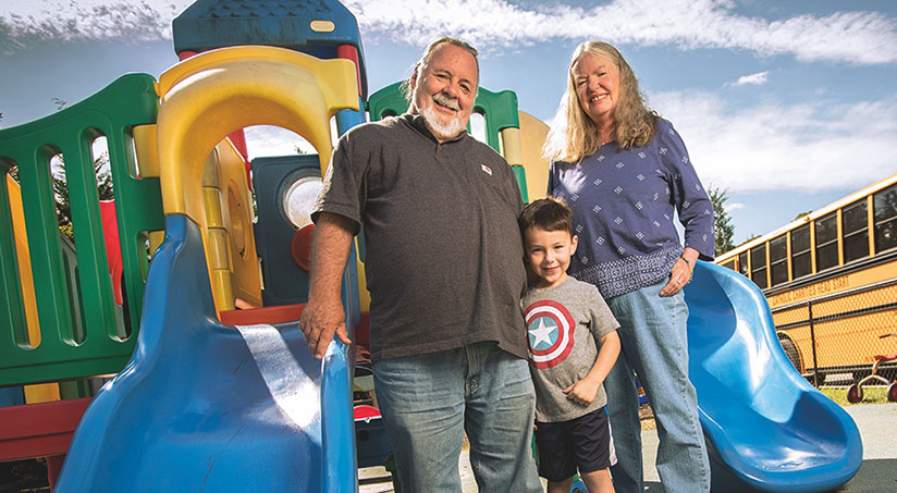 Elderly couple with a boy at a park