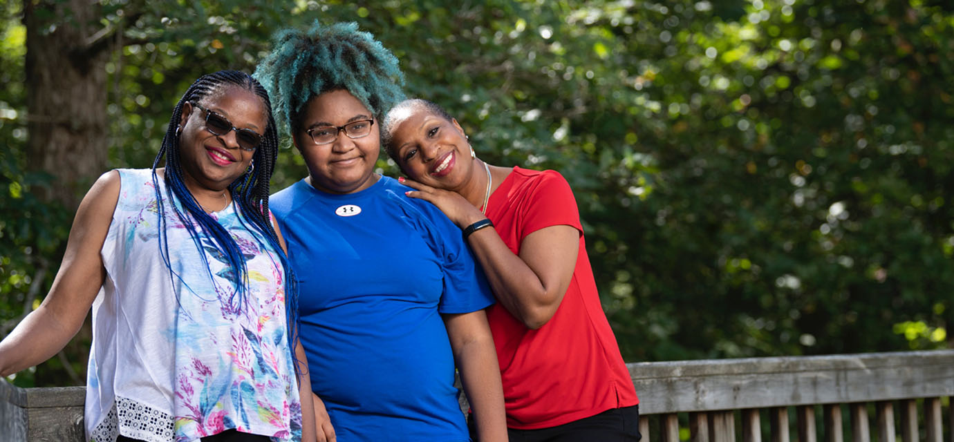Shot of Jonaya and the chase sisters smiling at the camera.